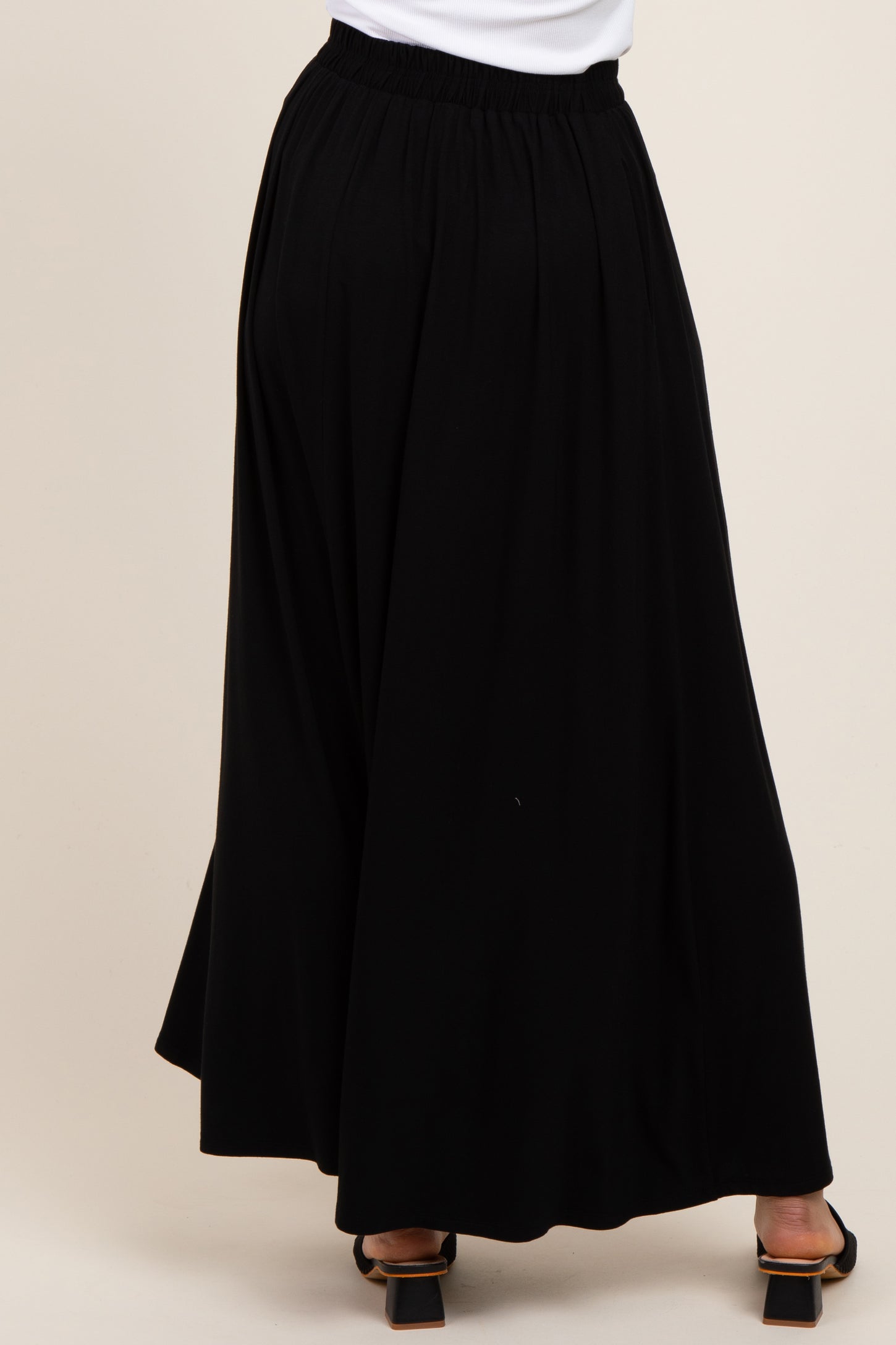 woman wearing a black maxi skirt with an elastic waistband and flowing silhouette