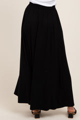 woman wearing a black maxi skirt with an elastic waistband and flowing silhouette
