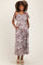 woman wearing a brown and white zebra print maternity maxi dress with pockets and tie straps, showing a baby bump