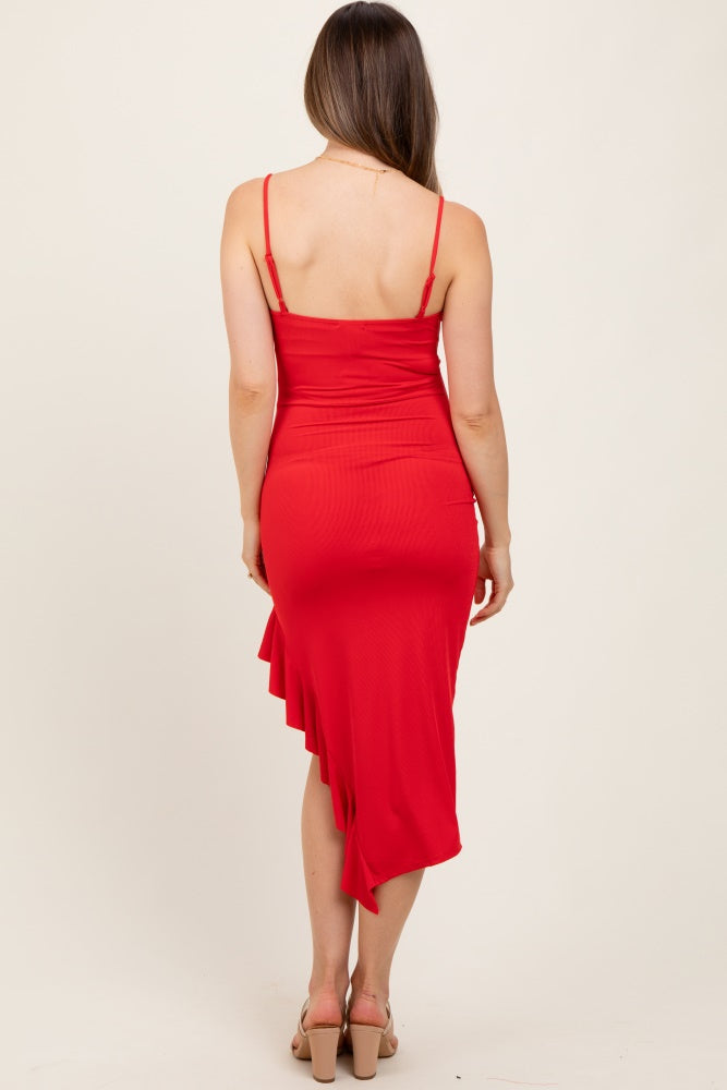 woman wearing a red maternity dress with an asymmetrical hem and thin straps, standing with her back to the camera