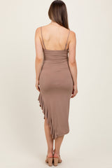 woman wearing a back view of a taupe maternity midi dress with a ruched bodice and asymmetrical ruffle detail