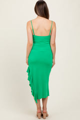woman wearing a green maternity dress with a ruffled hem and adjustable straps, showing the back view