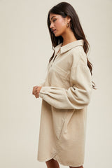woman wearing a beige corduroy shirt dress with a collar and side pockets
