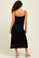 woman wearing a black tassel midi maternity dress with adjustable straps, seen from the back