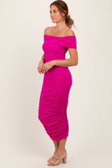 woman wearing a fitted hot pink off-the-shoulder midi dress with ruched detailing and a slim silhouette