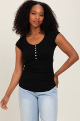 woman wearing a black ribbed short sleeve top with a scoop neckline and button detailing, paired with light blue jeans