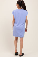 woman wearing a light blue maternity dress with short sleeves, view from the back