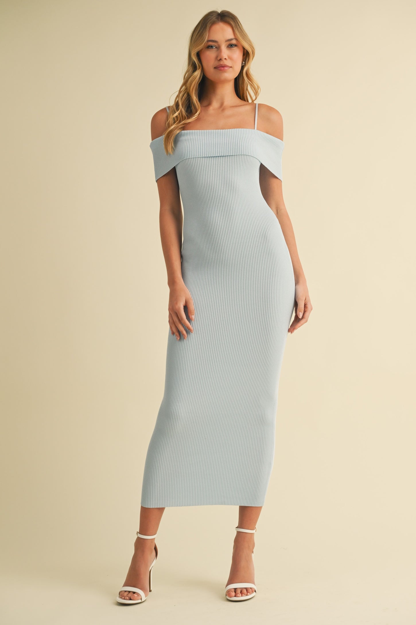 woman wearing a light blue ribbed off-shoulder midi dress with thin straps and a fitted silhouette