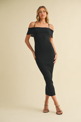 woman wearing a black off-the-shoulder fitted midi dress with thin straps and strappy heels