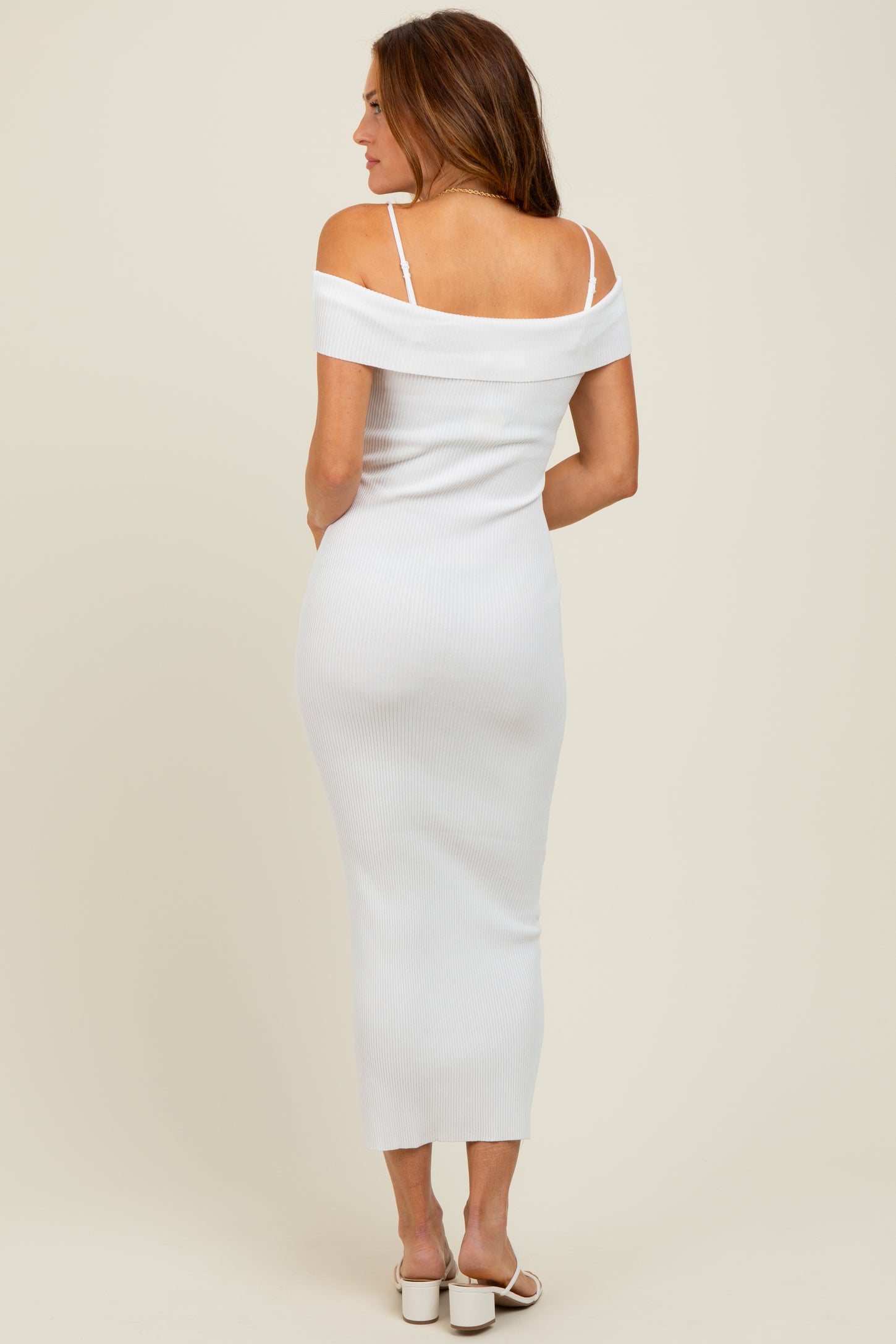woman wearing a white off-the-shoulder ribbed midi dress with thin straps and a form-fitting silhouette
