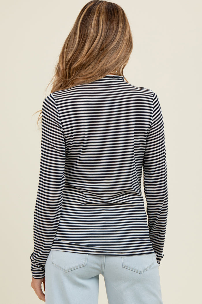 woman wearing a black and white striped maternity long sleeve top, showing the back view