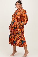 woman wearing a colorful patterned plus-size midi dress with long sleeves and a ruffled hemline