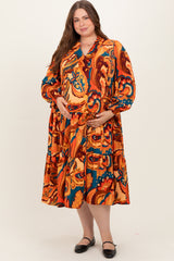 woman wearing a colorful printed maternity dress with long sleeves and a tiered skirt, holding her baby bump