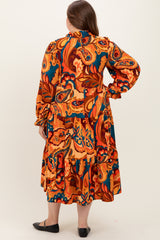 woman wearing a multicolored paisley print maternity dress with long sleeves and ruffled hemline, showing a baby bump from the back