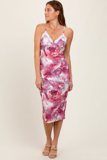 woman wearing a floral print midi dress with lace detail and adjustable spaghetti straps