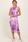 woman wearing a purple floral print midi dress with ruching detail and a sleeveless design