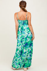 woman wearing a green floral maxi dress with adjustable straps and a smocked back, seen from the back
