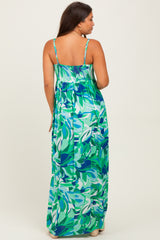 woman wearing a colorful floral print maternity maxi dress with adjustable straps and a smocked back