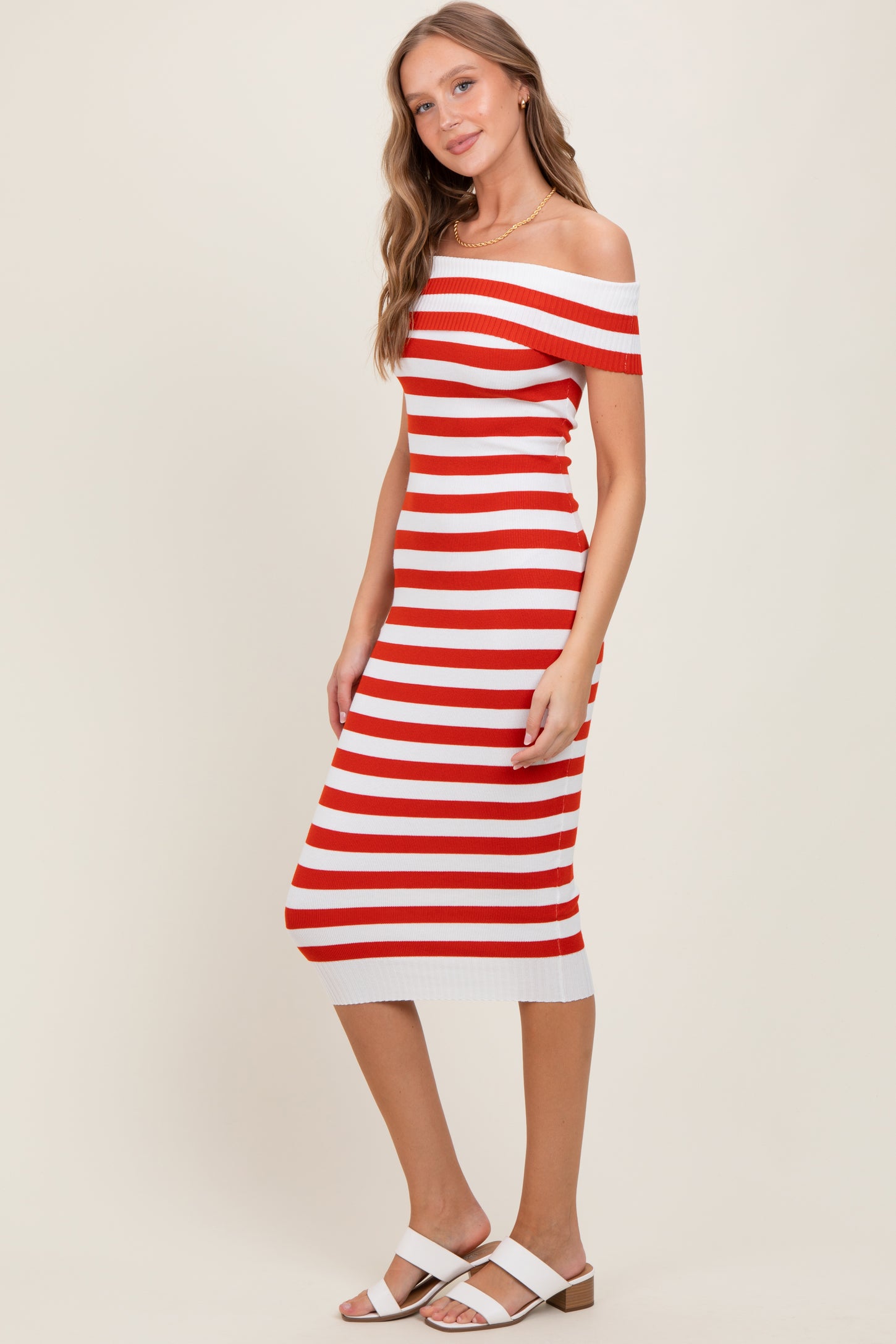 woman wearing a red and white striped off-the-shoulder midi dress and white heeled sandals