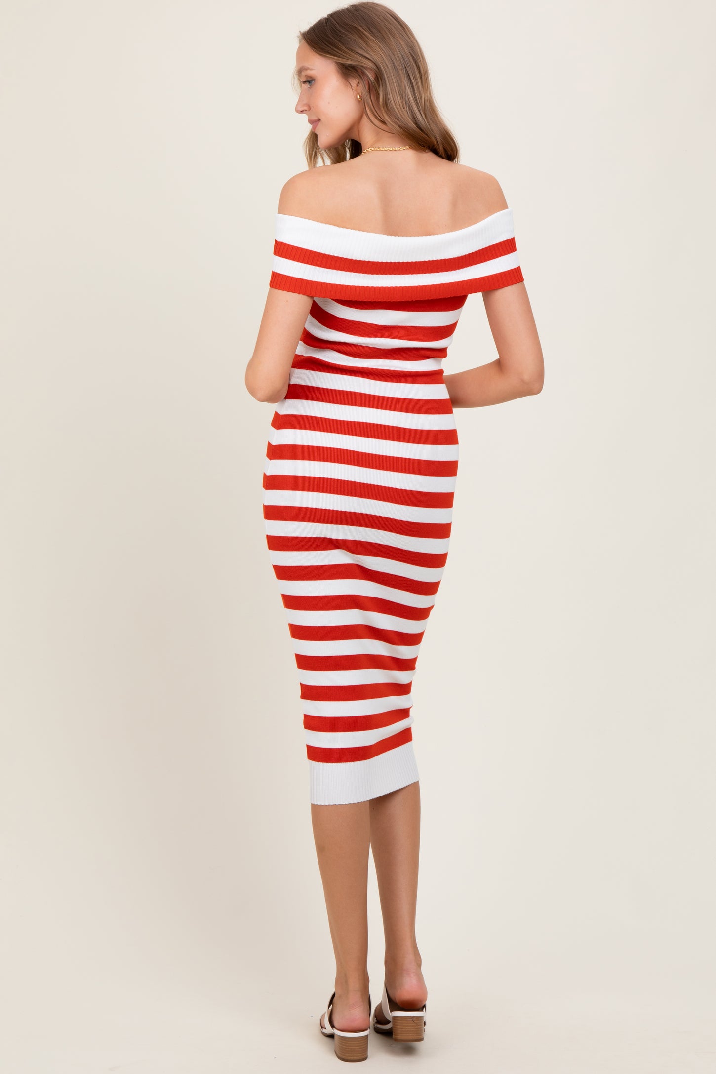woman wearing a red and white striped off-the-shoulder midi dress with a fitted silhouette and a ribbed texture