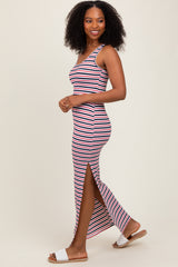 woman wearing a red and white striped maxi dress with side slits and walking confidently