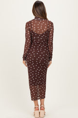 woman wearing a sheer brown polka dot maternity dress with long sleeves and a fitted silhouette