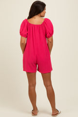 woman wearing a hot pink short sleeve maternity romper with a square neckline and side pockets