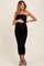 woman wearing a black strapless maternity dress with ruching and a visible baby bump