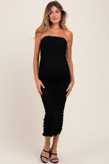 woman wearing a black strapless maternity dress with ruching and a visible baby bump