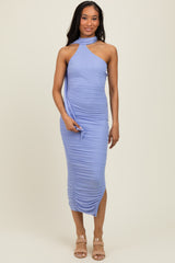 woman wearing a lavender sleeveless ruched midi dress with a halter neck and side draping
