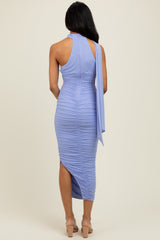 woman wearing a lavender ruched bodycon midi dress with a high neckline and a flowing shoulder tie detail