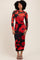 woman wearing a long sleeve black dress with a red floral print and a fitted silhouette