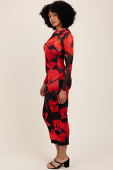 woman wearing a red floral long sleeve dress with sheer details and a fitted silhouette