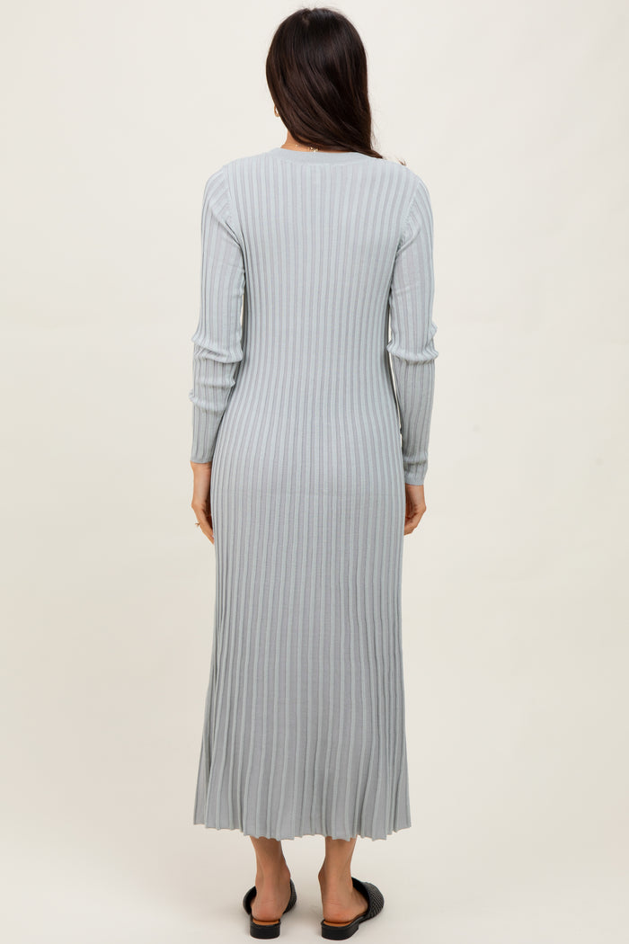 woman wearing a long sleeve light gray ribbed maxi dress viewed from the back