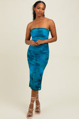 woman wearing a strapless turquoise bodycon midi dress with a smooth texture and a subtle abstract pattern
