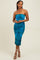 woman wearing a strapless turquoise bodycon midi dress with a smooth texture and a subtle abstract pattern