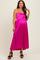 woman wearing a bright pink maternity maxi dress with spaghetti straps and a flowy silhouette, showcasing her baby bump