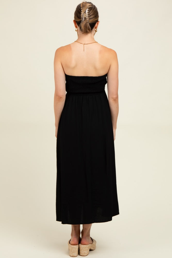 woman wearing a black maternity maxi dress with a smocked bodice, shown from the back