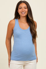 woman wearing a light blue ribbed maternity tank top and showing her baby bump