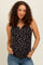 woman wearing a black floral maternity tank top and showing her baby bump