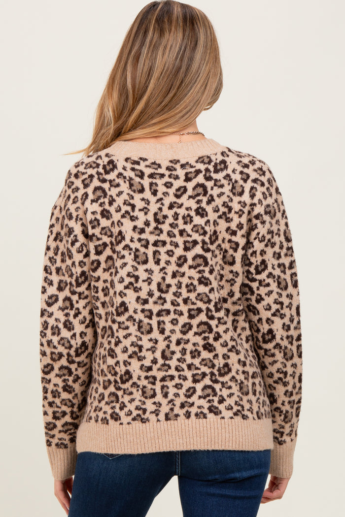 woman wearing a leopard print maternity sweater, with a relaxed fit and ribbed hem, shown from the back