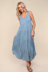 woman wearing a blue tiered maxi dress with a sleeveless design and a relaxed fit