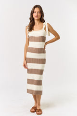 woman wearing a striped midi dress with knitted texture in beige and brown colors, featuring tie straps and a fitted silhouette