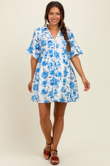 woman wearing a blue and white floral maternity dress with ruffled sleeves and a relaxed fit