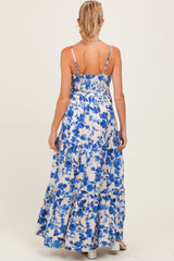 woman wearing a floral print maternity maxi dress with a smocked back and adjustable straps