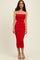 woman wearing a red strapless midi dress with a fitted silhouette and high slit, standing against a neutral background