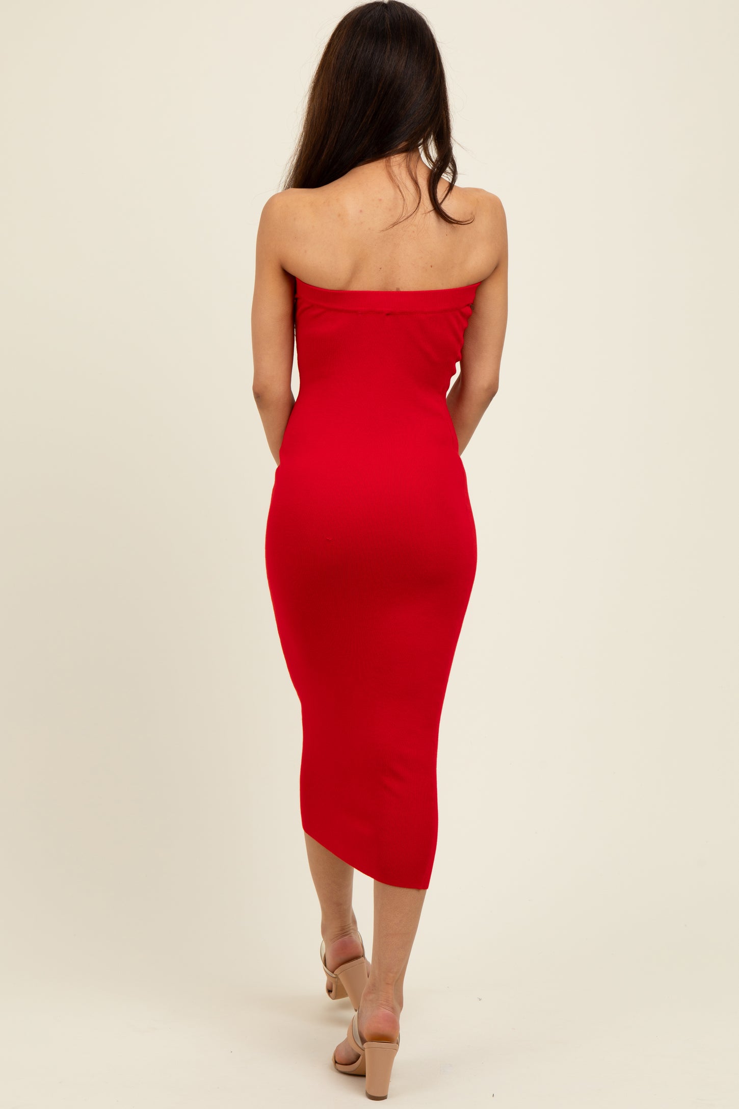 woman wearing a red strapless midi dress, shown from the back, hugging the body silhouette
