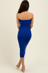 woman wearing a strapless royal blue midi dress, seen from the back, paired with nude heels