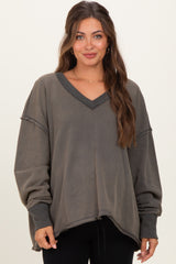 woman wearing a dark gray maternity sweatshirt with a v-neck and oversized fit