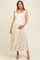 woman wearing a floral print maternity maxi dress with lace details and holding her baby bump